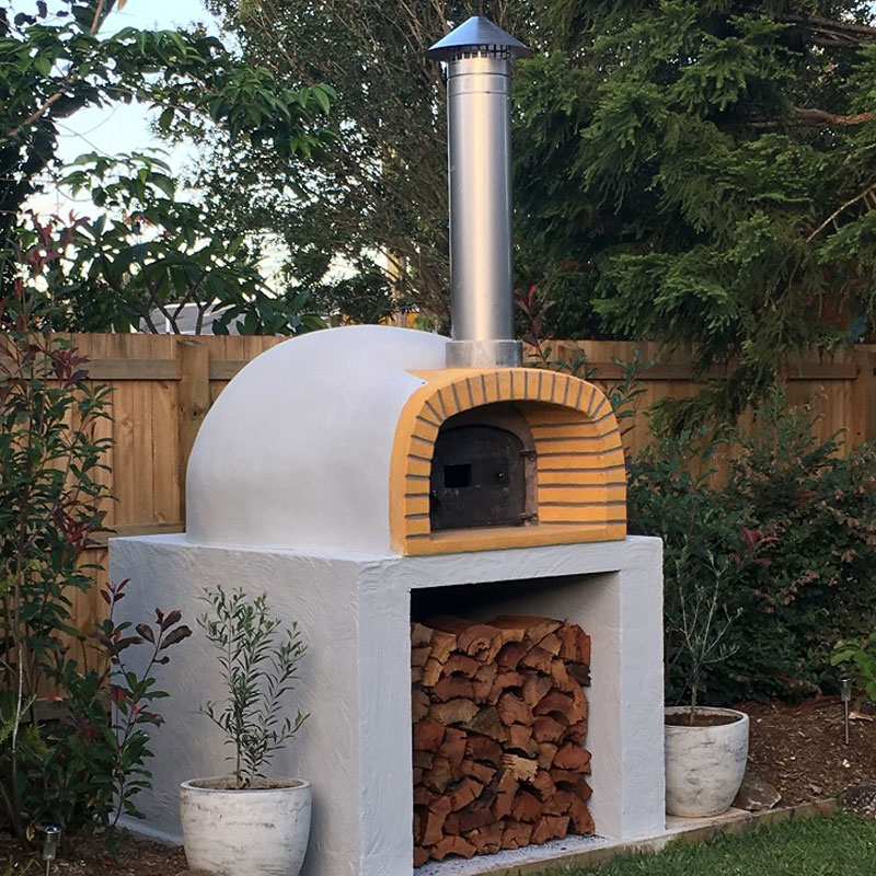 A beautiful completed pizza oven in a backyard setting